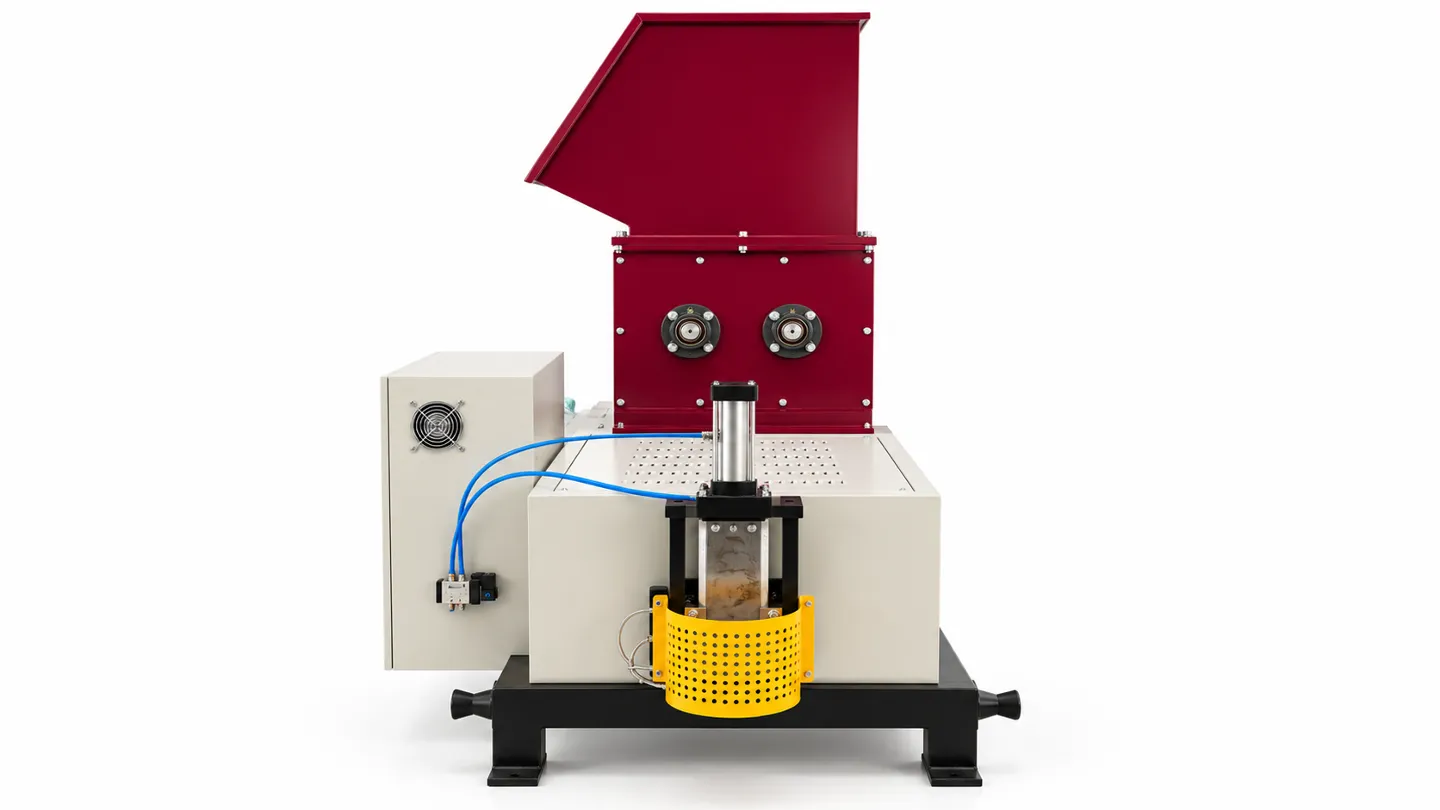 Discharge-end view of the EPS hot melt machine showing the outlet and protective guard